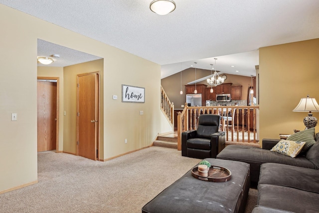 living room with a notable chandelier, a textured ceiling, stairway, lofted ceiling, and light colored carpet