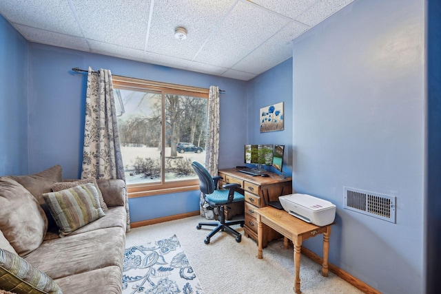 carpeted home office with a drop ceiling, visible vents, and baseboards