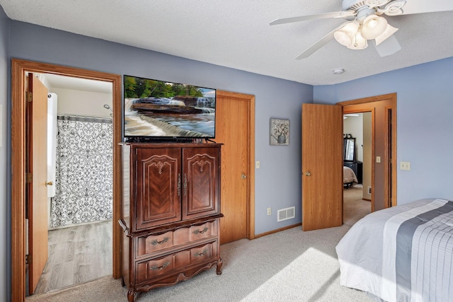 bedroom featuring visible vents, a textured ceiling, and carpet floors