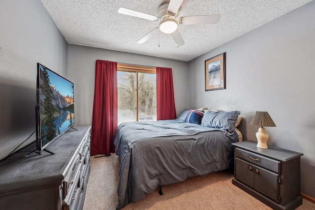 bedroom with light colored carpet, a textured ceiling, and a ceiling fan