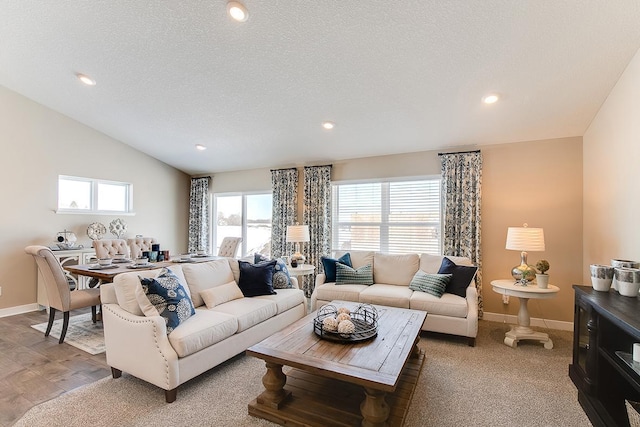 living room with vaulted ceiling, a textured ceiling, recessed lighting, and baseboards