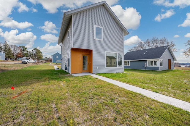 rear view of property with a yard