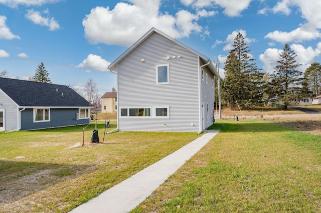 view of side of property with a lawn