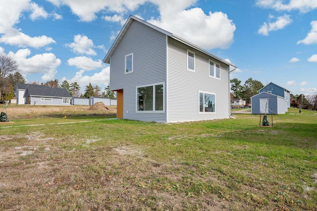 back of property featuring a lawn