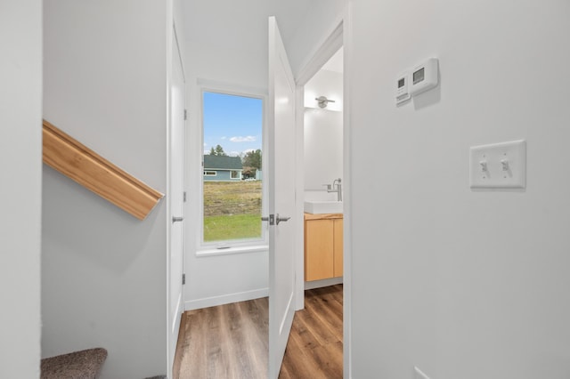 hall featuring hardwood / wood-style floors and sink