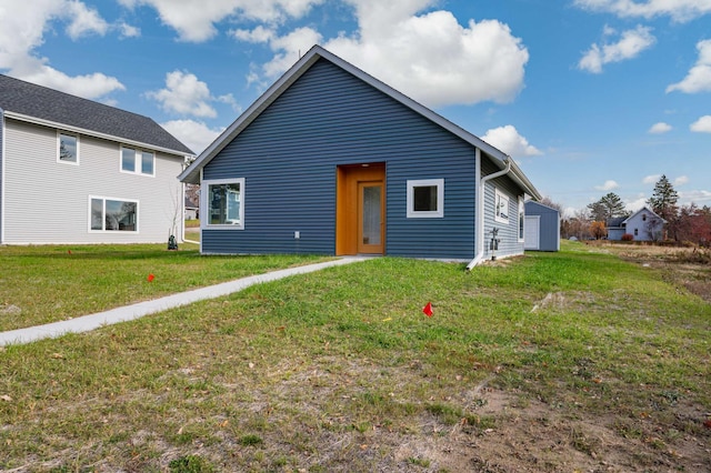 rear view of house with a yard