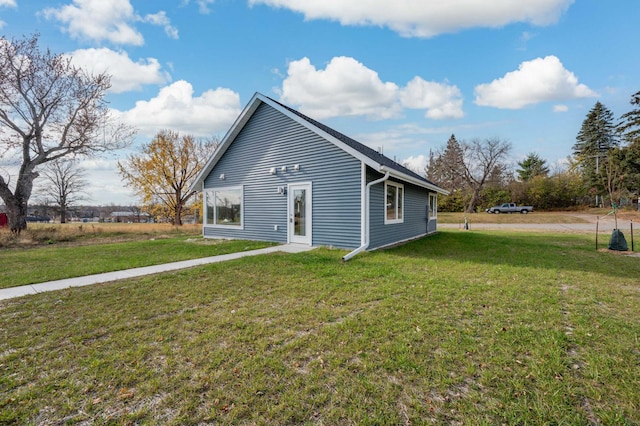 view of side of home with a lawn