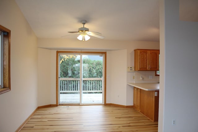 interior space with ceiling fan and light hardwood / wood-style flooring