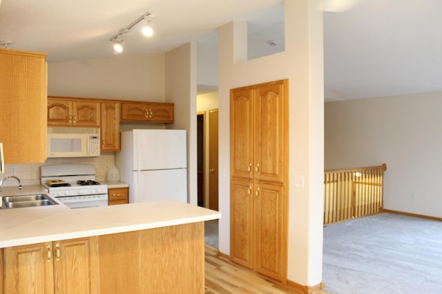 kitchen featuring sink, high vaulted ceiling, kitchen peninsula, white appliances, and light carpet