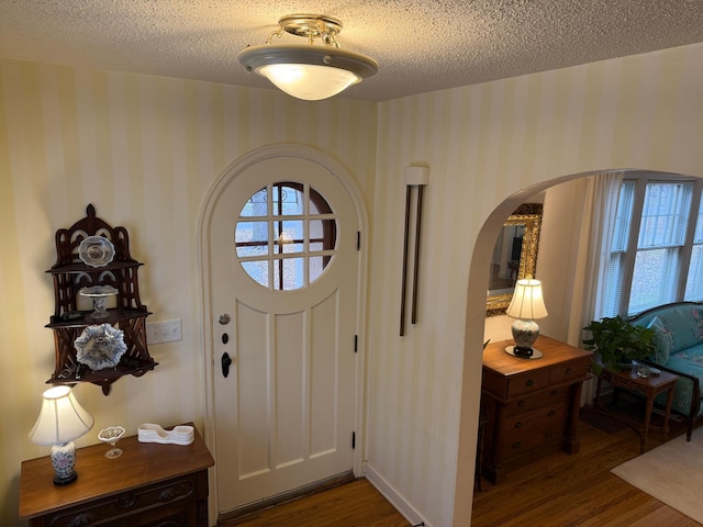 foyer with dark hardwood / wood-style floors and a textured ceiling