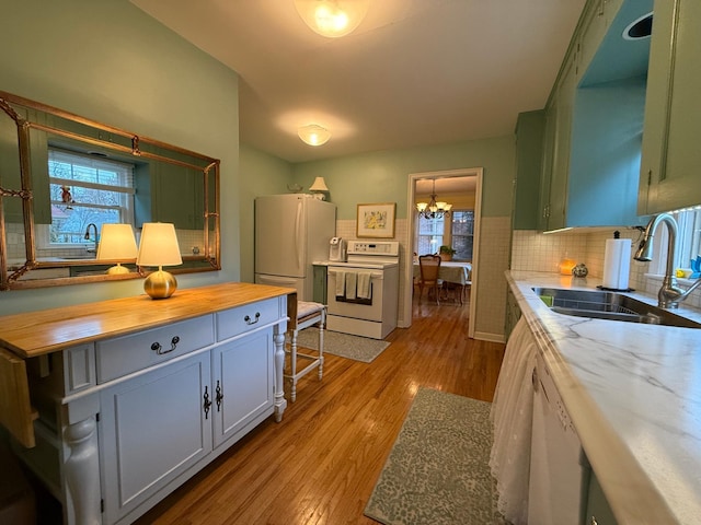 kitchen featuring sink, wooden counters, white appliances, and light wood-type flooring