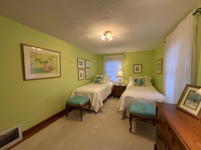 bedroom featuring carpet floors and a textured ceiling