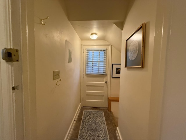 doorway to outside with vaulted ceiling