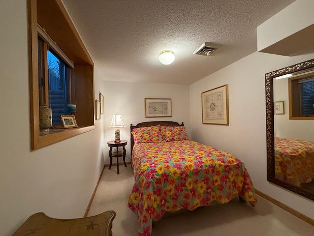 bedroom featuring carpet floors and a textured ceiling