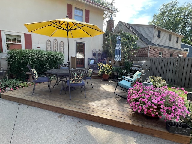 wooden terrace with a grill