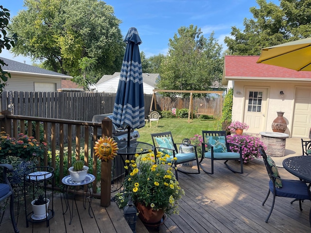 wooden terrace featuring a yard