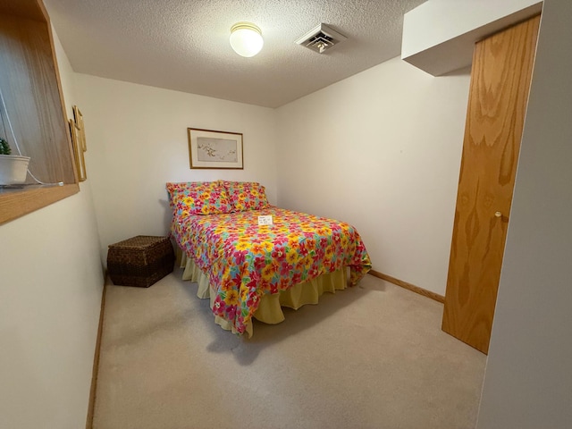 carpeted bedroom with a textured ceiling