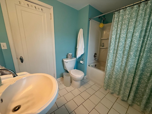 full bathroom with toilet, sink, tile patterned floors, and shower / tub combo with curtain