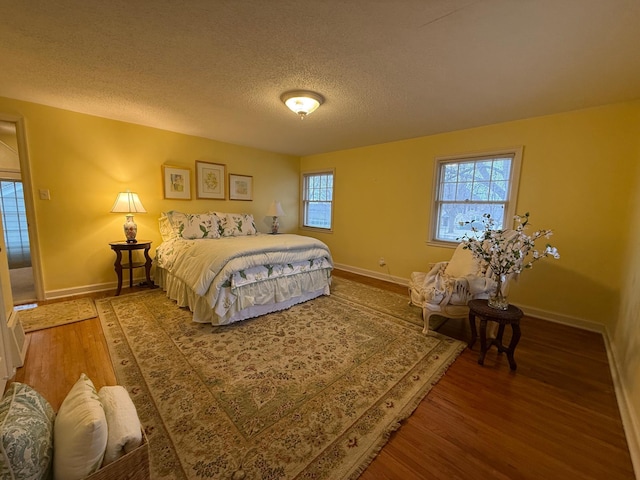 bedroom with hardwood / wood-style flooring and a textured ceiling