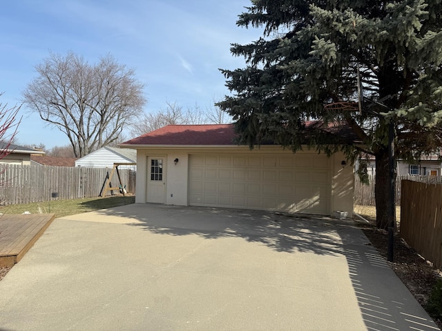 detached garage featuring fence