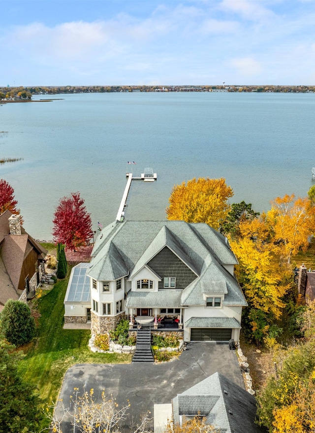 birds eye view of property with a water view