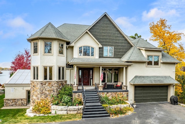 view of front of property featuring a garage and covered porch