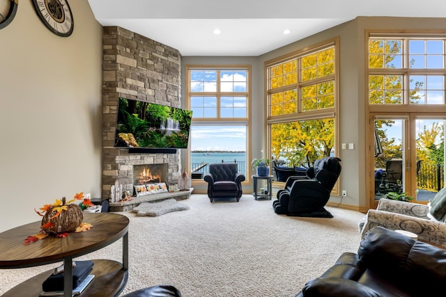 carpeted living room featuring a fireplace