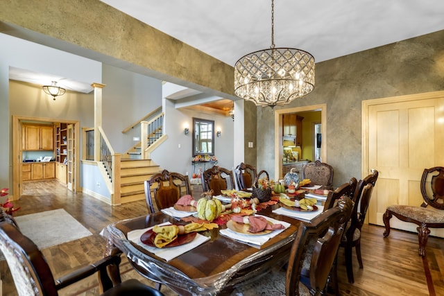 dining room with wood-type flooring and a notable chandelier