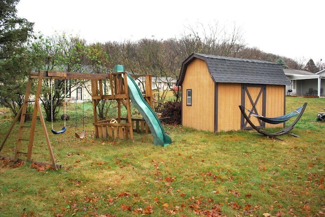 view of jungle gym featuring a yard and a shed