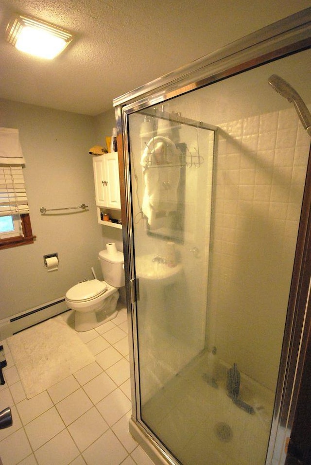 bathroom featuring a baseboard heating unit, a textured ceiling, toilet, an enclosed shower, and tile patterned floors