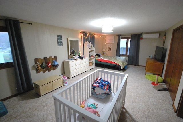 carpeted bedroom with a wall mounted air conditioner and a textured ceiling