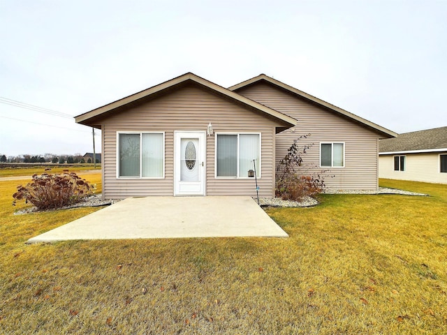 view of front of house with a patio area and a front yard