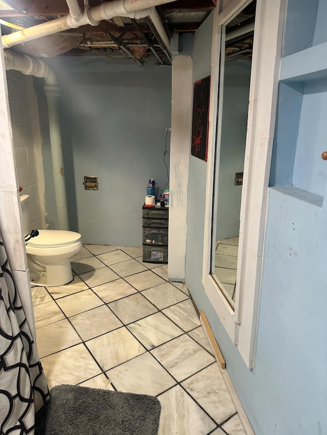 bathroom with tile patterned floors and toilet