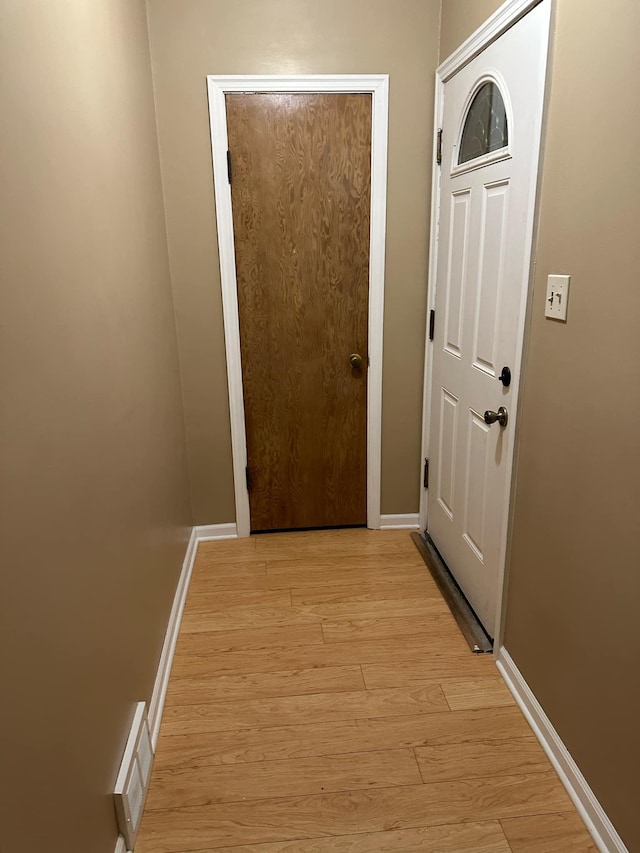 entryway with light hardwood / wood-style floors