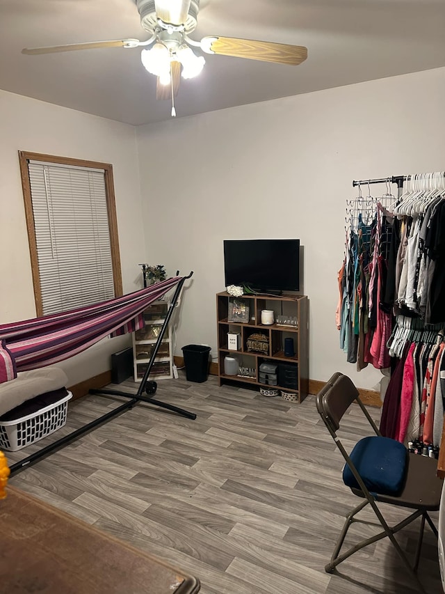 interior space with ceiling fan and wood-type flooring