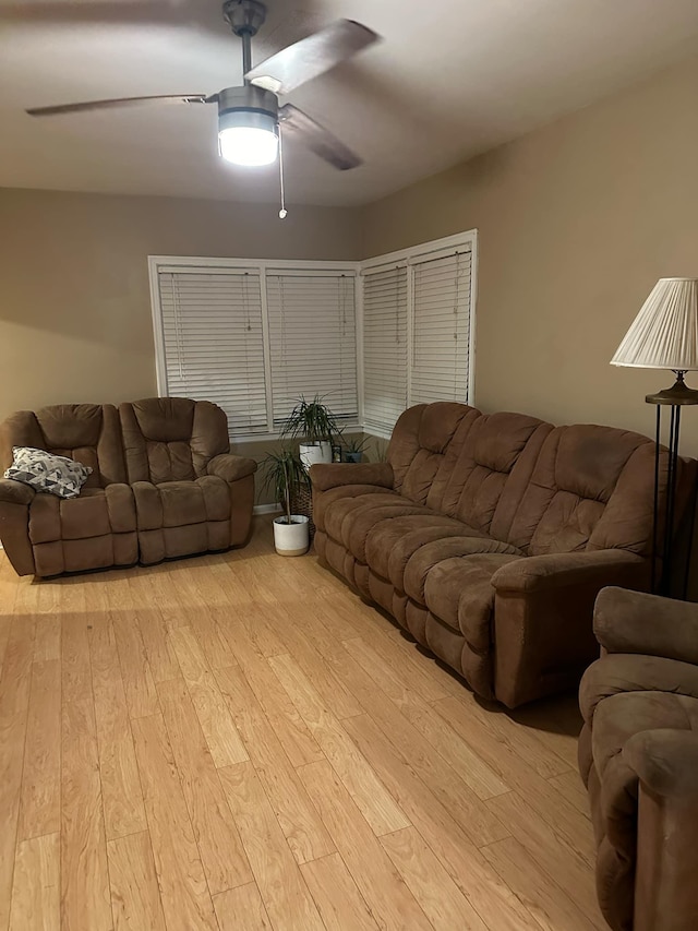 living room featuring ceiling fan and light wood-type flooring