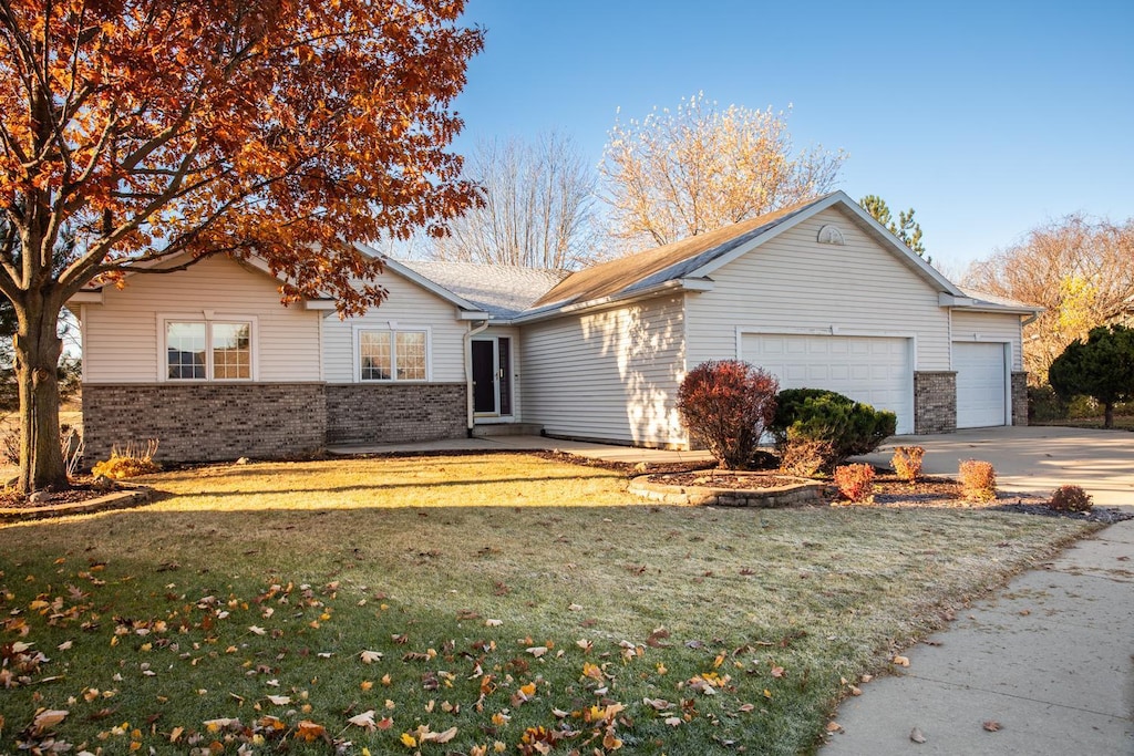 ranch-style house with a front lawn and a garage