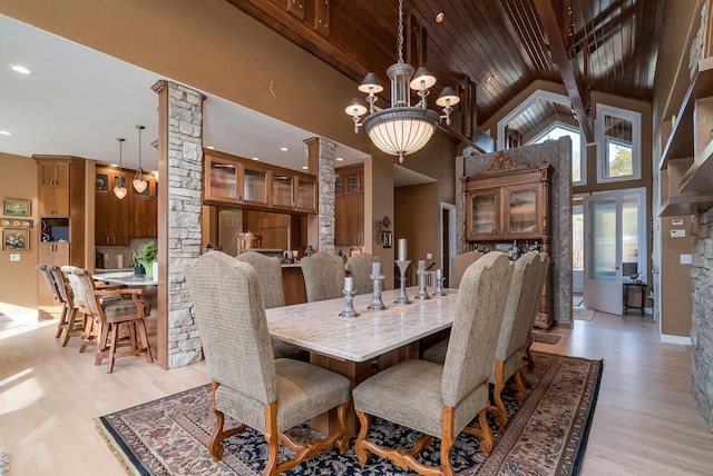 5441 Raven Point Rd, Spring Lake Twp, MN 55372 - dining space with ornate columns, high vaulted ceiling, light wood-style flooring, a chandelier, and wood ceiling