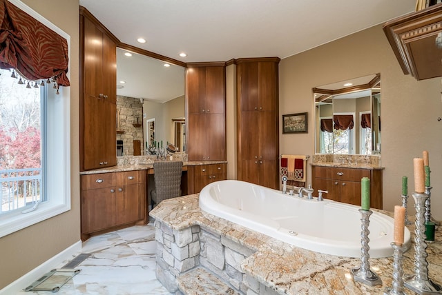 5441 Raven Point Rd, Spring Lake Twp, MN 55372 - bathroom featuring two vanities, plenty of natural light, marble finish floors, a garden tub, and recessed lighting
