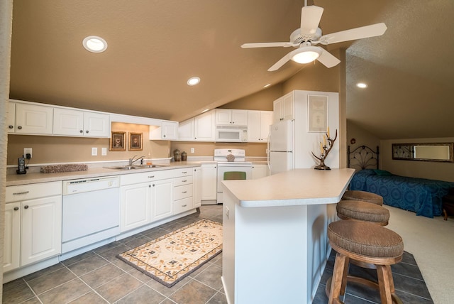 5441 Raven Point Rd, Spring Lake Twp, MN 55372 - kitchen featuring white appliances, a sink, vaulted ceiling, a peninsula, and a kitchen breakfast bar