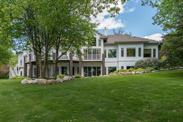 5441 Raven Point Rd, Spring Lake Twp, MN 55372 - back of property featuring a chimney, a yard, a balcony, and stucco siding