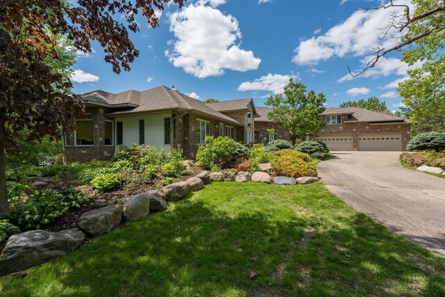 5441 Raven Point Rd, Spring Lake Twp, MN 55372 - view of front of house featuring brick siding, concrete driveway, a front lawn, and an attached garage