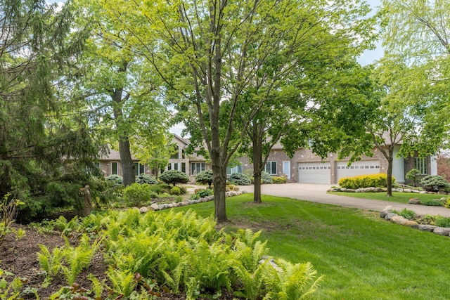 5441 Raven Point Rd, Spring Lake Twp, MN 55372 - view of property hidden behind natural elements featuring concrete driveway, a front yard, brick siding, and a garage