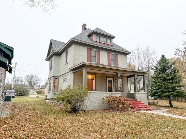 view of front of property with a front lawn and covered porch