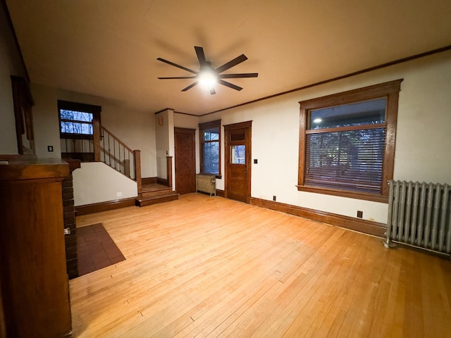 unfurnished bedroom with radiator and light wood-type flooring