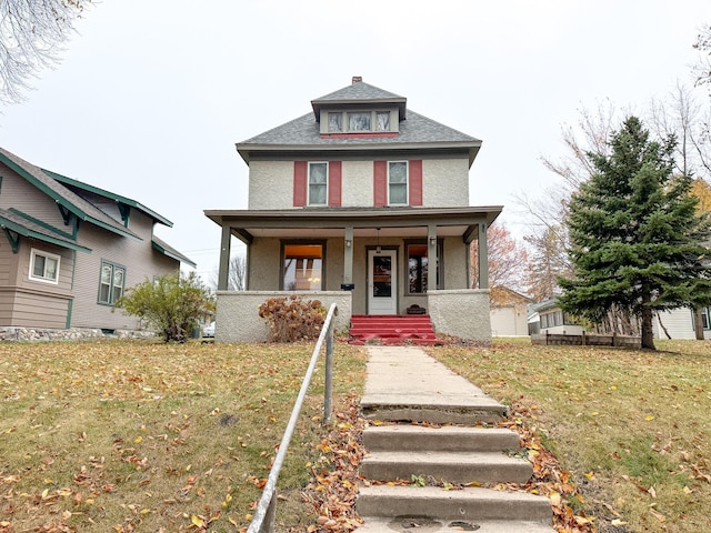 view of front of home featuring covered porch and a front yard