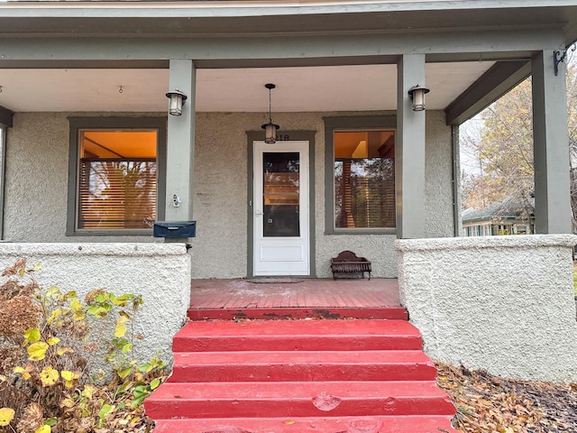 view of exterior entry with covered porch