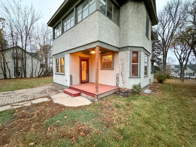 view of front of property featuring a front lawn and a wooden deck