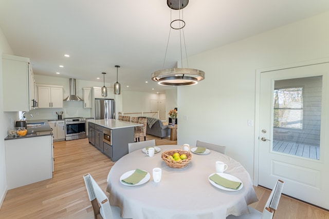 dining space featuring light hardwood / wood-style floors and sink