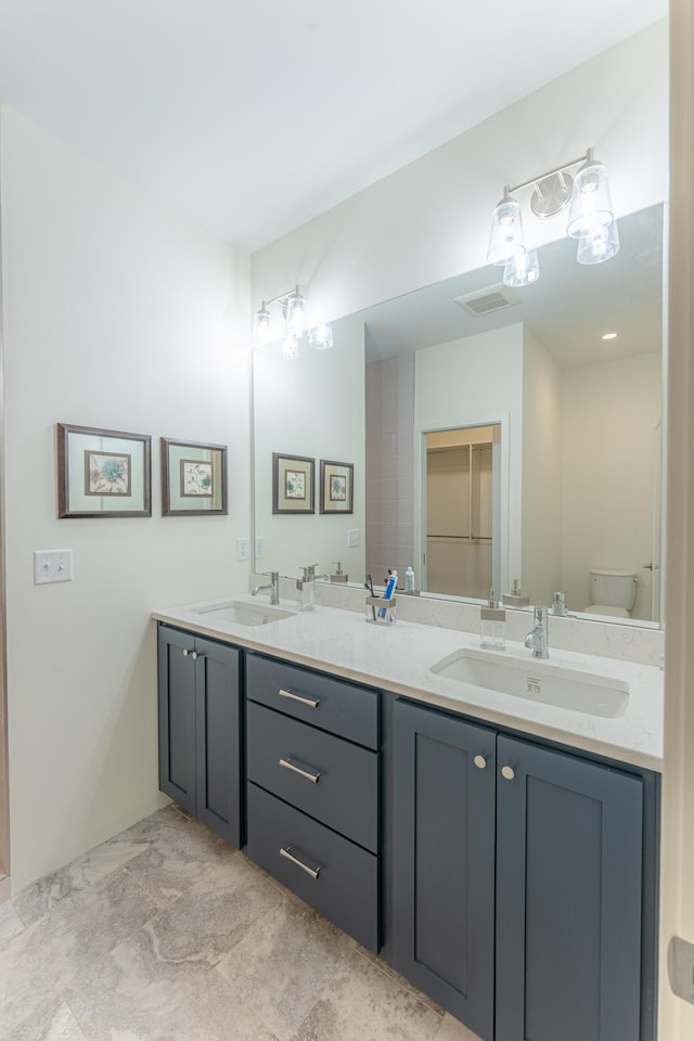 bathroom featuring vanity and toilet